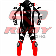 Front-facing image of Jack Miller's Yamaha MotoGP 2025 test suit in black, white, and red, showing sponsor patches from Quad Lock and CAT, number 43 on chest and legs, Ruby Racing on collar, and armored knees – pro-grade racing suit.