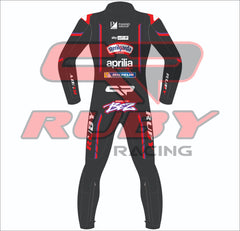 Back view of Marco Bezzecchi’s 2025 Aprilia MotoGP race suit in black with red detailing. Features sponsor logos from Sterilgarda, Aprilia Racing, Piaggio Group, Michelin, and RUBY branding on arms and legs. The BEZZ logo is placed prominently on the lower back.