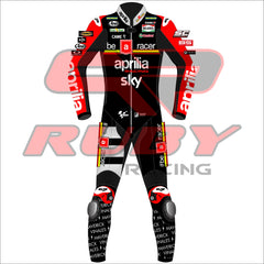Front view of the 2024 Maverick Viñales Aprilia Racing suit design for British GP featuring a black, red, and white color scheme with prominent sponsor logos like Aprilia, Sky, Michelin, and Ruby. The suit showcases detailed graphics on the legs and arms, personalized for Maverick Viñales.