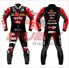 Front and back view of the 2024 Maverick Viñales Aprilia Racing suit design for British GP featuring a black, red, and white color scheme with prominent sponsor logos like Aprilia, Sky, Michelin, and Ruby. The suit showcases detailed graphics on the legs and arms, personalized for Maverick Viñales.