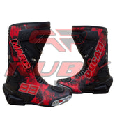 Marc Márquez 93 Ducati motorcycle boots front angle highlighting bold red-black color and metal toe sliders.