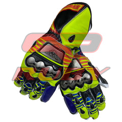 A pair of Valentino Rossi 2016 MotoGP racing gloves, showcasing a dynamic design with vibrant yellow, blue, red, and black colors. These gloves feature reinforced knuckles with prominent metallic plates, offering both safety and the distinctive style of Rossi's 2016 MotoGP gear