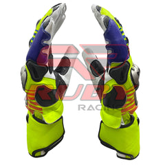 Side profile of a pair of Valentino Rossi 2016 MotoGP racing gloves, emphasizing their bold and vibrant yellow, blue, red, and black color scheme. The gloves feature reinforced protective elements, ergonomic design, and premium stitching, reflecting the high-performance standards of Rossi's 2016 racing gear.