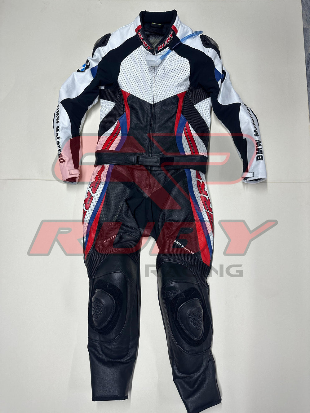 Front view of the BMW Double R Men's Motorbike Race Suit. The suit features white, black, red, and blue accents with prominent BMW Motorrad branding on the chest and sleeves. Designed for racing, it includes padded protection on the shoulders, elbows, and knees, combining safety with a sleek, aerodynamic design