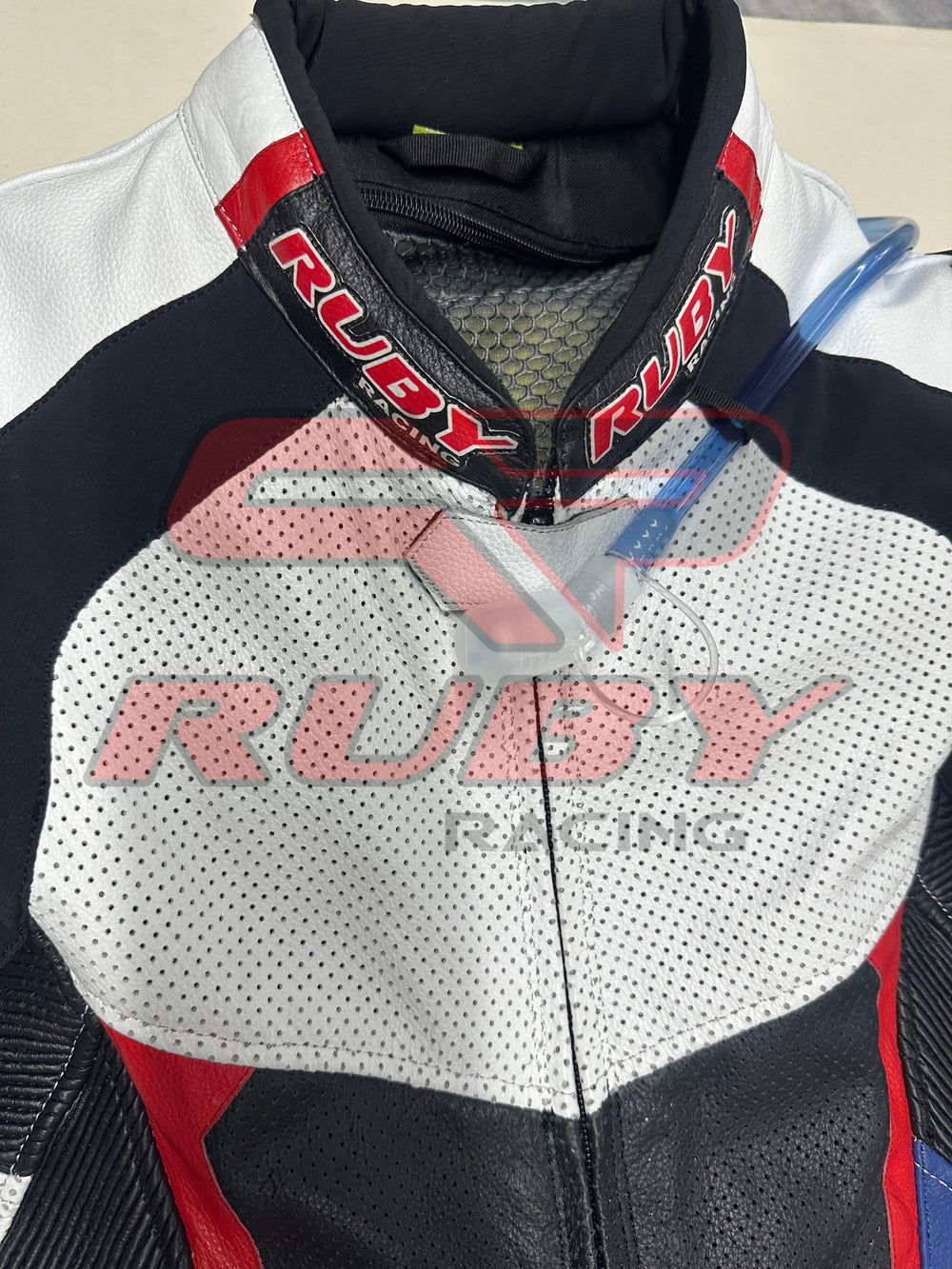 Front view of the BMW Double R Men's Motorbike Race Suit. The suit features white, black, red, and blue accents with prominent BMW Motorrad branding on the chest and sleeves. Designed for racing, it includes padded protection on the shoulders, elbows, and knees, combining safety with a sleek, aerodynamic design