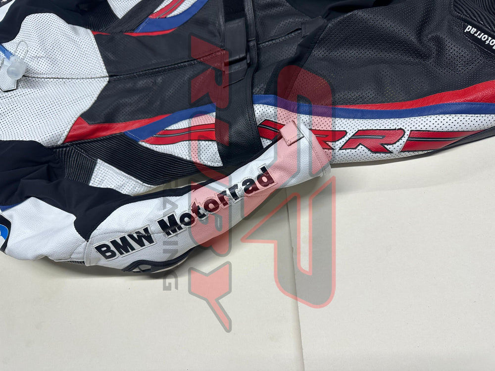 Close-up side view of the BMW Double R Men's Motorbike Race Suit, highlighting the white sleeve with 'BMW Motorrad' branding and the black, red, and blue accents running down the side of the suit.