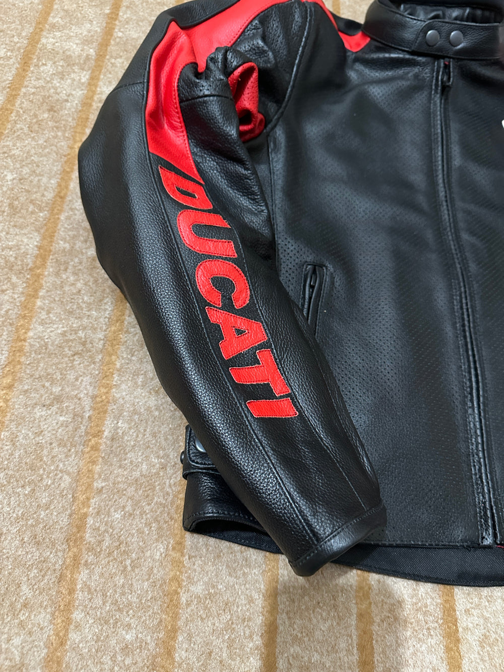Closeup View of Ducati C4 Motorcycle Leather Jacket – Black and Red Design Featuring Ducati Logo, Premium Perforated Leather, and Stylish Fit for Riders