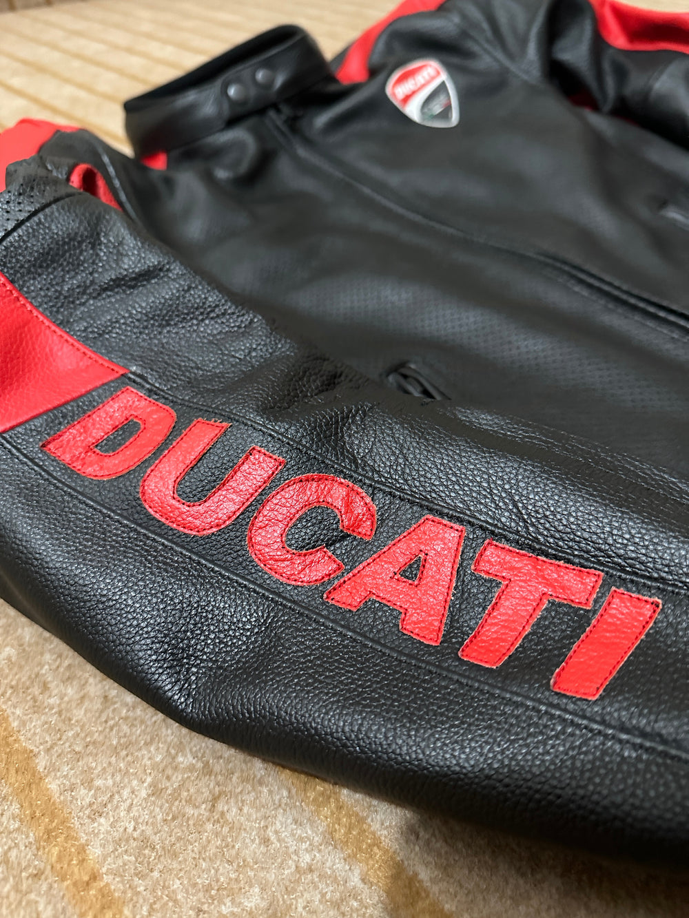 Closeup View of Ducati C4 Motorcycle Leather Jacket – Black and Red Design Featuring Ducati Logo, Premium Perforated Leather, and Stylish Fit for Riders