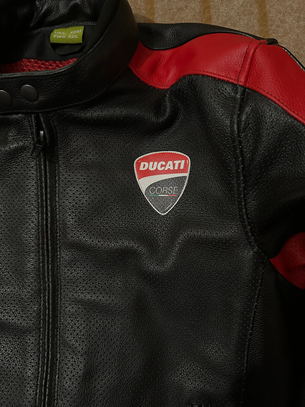 Closeup View of Ducati C4 Motorcycle Leather Jacket – Black and Red Design Featuring Ducati Logo, Premium Perforated Leather, and Stylish Fit for Riders