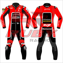 Jorge Martin's 2024 Pramac Race Suit for the British GP, shown in front and back views. The suit is predominantly red with 'PRIMA PRAMAC DUCATI' branding on the chest, complemented by sponsor logos including Michelin, FIAMM, and the number 89. The back features a black panel with additional logos, including 'PRIMA PRAMAC' and 'MICHELIN.' The suit includes protective padding at the knees and elbows, designed for optimal safety during high-speed racing events.