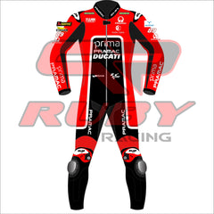 Front view of Jorge Martin's 2024 Pramac Race Suit for the British GP. The suit is predominantly red with black and white accents, featuring prominent 'PRIMA PRAMAC DUCATI' branding on the chest. Sponsor logos such as Michelin, FIAMM, and Akrapovic are visible on the shoulders and arms, with the number 89 on the left shoulder. The suit has black leg panels with 'PRAMAC' branding in white and protective knee pads integrated for added safety