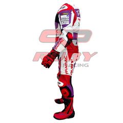 Left side view of the 2023 Ducati Pramac MotoGP Racing Leather Suit worn by Jorge Martin. The suit showcases sponsor logos like Pramac, Akrapovic, and Wallife, along with protective padding on the elbows and knees. Red boots and gloves complement the purple, red, and white color scheme, designed for high-performance motorcycling