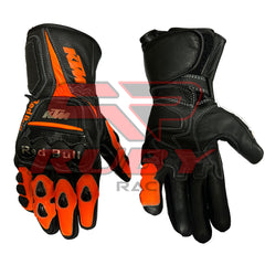 Pair of KTM Red Bull Speed Racing Gloves in black and orange leather. The gloves feature the KTM logo on the top and knuckle area, with Red Bull branding on the knuckles. The gloves are designed for high-performance motorbike racing, offering superior protection and a secure fit, with reinforced stitching and padded areas for maximum durability.