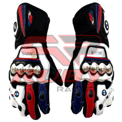 A pair of BMW S1000RR motorcycle racing gloves in black, white, red, and blue colors. The gloves feature protective knuckle guards, the BMW logo on the wrist, and 'BMW Motorrad' branding. The design includes accents in red and blue, with the gloves' sturdy build showcasing reinforced areas for enhanced safety during riding.