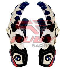 A close-up view of BMW S1000RR motorcycle racing gloves in black, white, red, and blue colors, focusing on the side profile. The gloves display the BMW logo on the wrist, with detailed protective padding along the fingers and knuckles. The design highlights the gloves' ergonomic structure and reinforced areas for enhanced grip and safety while riding.