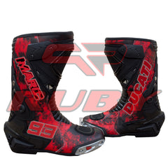 Marc Márquez 93 Ducati motorcycle boots front angle highlighting bold red-black color and metal toe sliders.