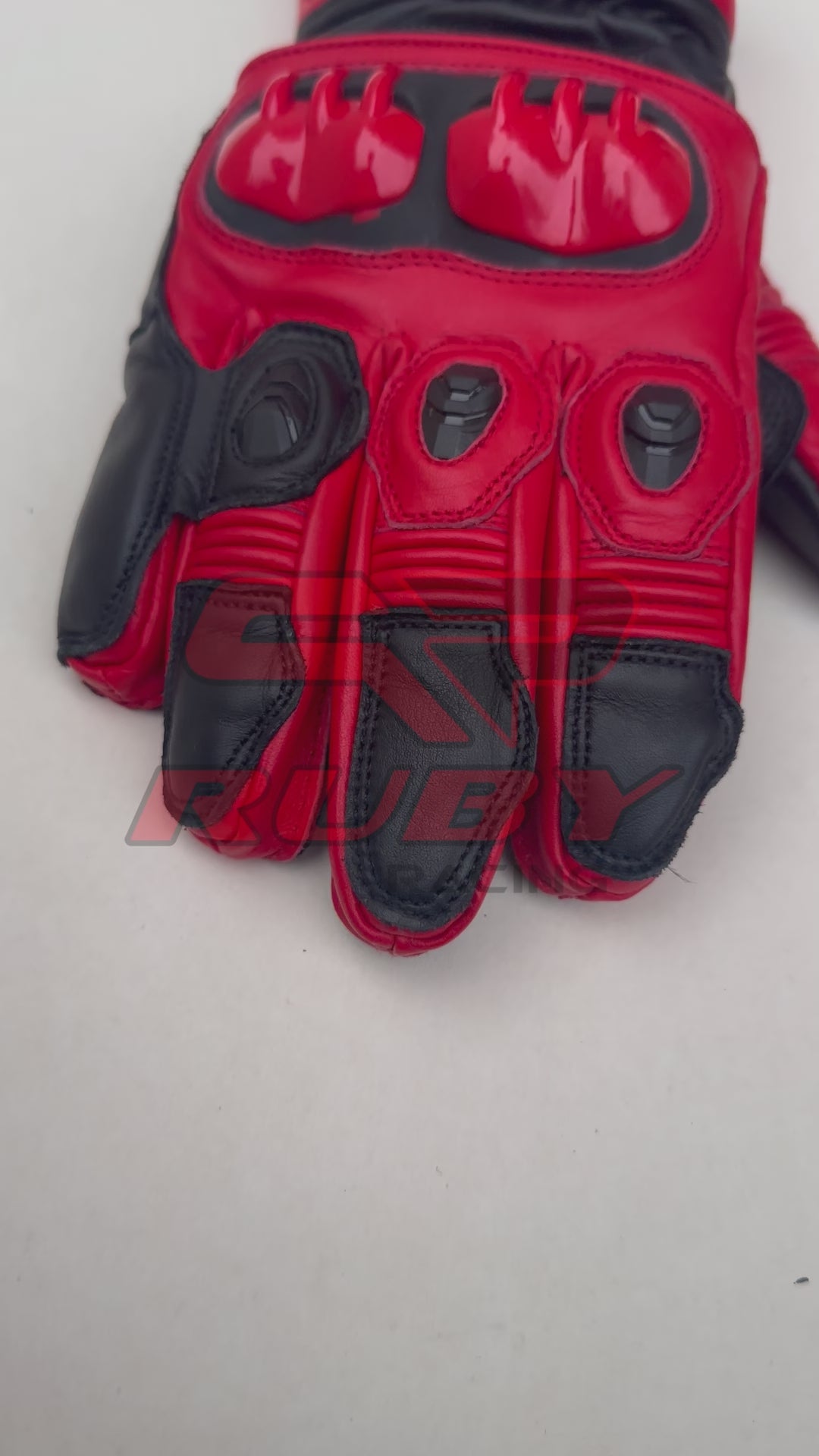 Video of Jorge Martin MotoGP 2024 Race Gloves in striking red and black leather. These high-performance gloves feature enhanced knuckle protection, reinforced stitching, and aerodynamic design, ideal for professional racing.