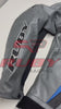 Front view of the BMW Motorrad Racing Motorcycle Jacket in gray with black, blue, and red detailing. The jacket displays prominent sponsor logos and is crafted from premium leather, ideal for motorbike riders seeking style and protection