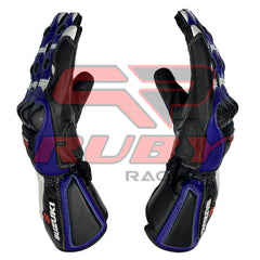 Suzuki GSX-R motorbike racing gloves in black and blue with white accents. Features include reinforced knuckle armor, carbon fiber details, and Suzuki branding on the wrist guards. The gloves are ergonomically designed with pre-curved fingers for enhanced grip and control.